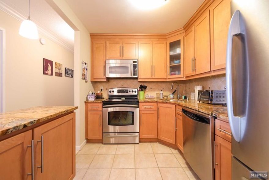 Welcome home to your own private oasis which is away from the hustle and bustle of the city but close enough to transportation to NY if you want to enjoy the urban scene. Enjoy your personal private space that offers renovated kitchen with granite countertops, spacious cabinets with island, granite counters; renovated baths and wood floor. The enclosed terrace offers a space to relax and enjoy the sunsets. Master bedroom offers a large walk-in closet with entry to the master bath; custom wood dressers are included in both bedrooms and living room. Property being sold "As Is". Transit to NYC is near and you are close to all major highways. Indoor parking is $100 and outdoor parking $80