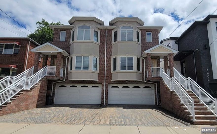 Excellent opportunity to live in Palisades Park. Wonderful details throughout the home. Living room with fireplace and hardwood floors through the property. Spacious modern eat in kitchen with stainless steel appliances, wet bar W/wine cooler and sliding door to deck. Second floor features a large Master bedroom with full bath and jacuzzi tub. 2 bedrooms with full bath and laundry room. Finished basement has an office or extra bedroom suite with a full bath. This house conveniently located within walking distance to NYC transportation and an easy access to NJ major highways and shops. Don't miss seeing this lovely home.