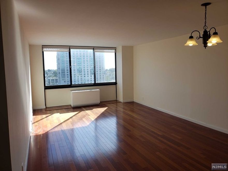 Beautiful south facing 1 bedroom/1 bathroom with Brazilian cherry wood floors throughout! NYC Skyline views from the master bedroom and living room. 2 Large walk in closets. Rent includes heat/AC, TV, Internet and a covered parking space. Building offers 24 hour concierge, full gym, pool, sauna, community room and laundry on the floor.