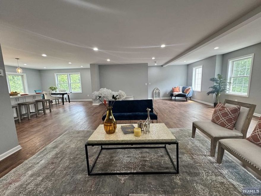 Beautifully crafted, this new construction luxury townhome in Wanaque is a stunning example of modern living. Spanning over 3,200 sq/ft, this home features a spacious family room, a welcoming living room, and an elegant dining area. The gourmet eat-in kitchen is perfect for culinary enthusiasts, while the family room offers a cozy space for relaxation. The master suite is a true retreat, boasting his and hers walk-in closets and a luxurious master bath. There are two additional well-appointed bedrooms and a full bathroom to accommodate family or guests. Convenience is key with a two-car garage, and the outdoor space includes both a patio and a deck, ideal for entertaining or enjoying serene moments. This townhome combines luxury and comfort in a prime Wanaque location.