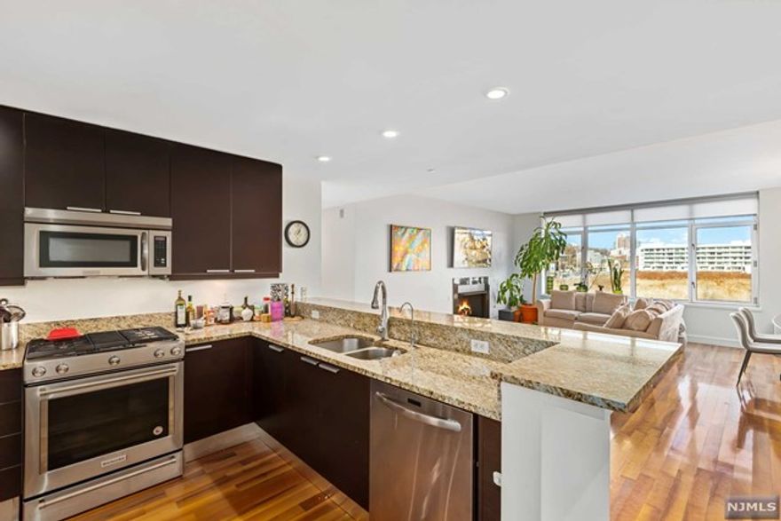 Did someone say LUXURY? Welcome home to The Watermark on the Hudson,where everything is at your fingertips! This 1588 sq ft 2 bedroom/2 bath open floor plan home offers river views,plenty of natural light,Hardwood floors,custom window treatments,maplewood kitchen cabinetry w/ granite countertops,stainless steel appliances,&garbage disposal,a state of the art ensuite bathroom w/ marbled bath,& 2 deeded garage spots. Plenty of storage space available,w/ not one,but 2 sizable walk-in closets.AND did we mention the gas fireplace that offers the perfect ambiance in the spacious living room?If that's not enough,this white-glove building doesn't spare a single amenity,offering over 40,000 sq ft of them,from a 24/7 concierge,valet service, health club, state of the art fitness center,which includes saunas and steam rooms,spa,hot tubs,and library to both indoor/outdoor pools, gold simulator,professional grade theatre, and more!Additionally,an effortless commute!