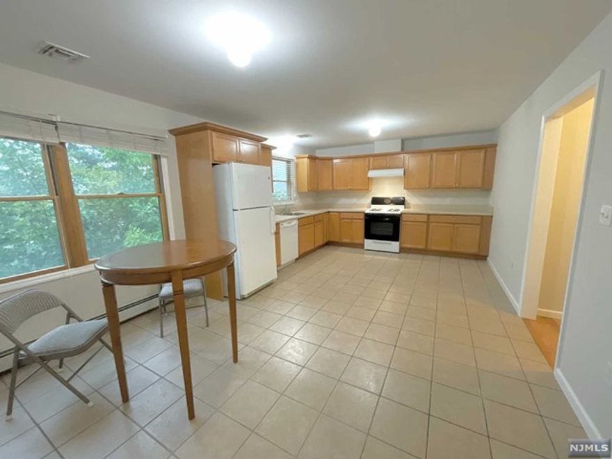 Spacious apartment on a second floor of a multi family home with parking and private laundry in the unit! This apartment features hardwood floors through out, central air, a lot of closet space, and large windows that allow an abundance of natural light in. This apartment offers a great layout with a large master bedroom with its own private bath and 2 other large bedrooms on one side. On the other side of the apartment it offers a dining area for a formal dining room table, a kitchen with space for an table or island, and a large living with large windows and an adjacent bathroom. This apartment is conveniently located by the train station, shopping area, and restaurants. No smoking or pets are permitted in this apartment.