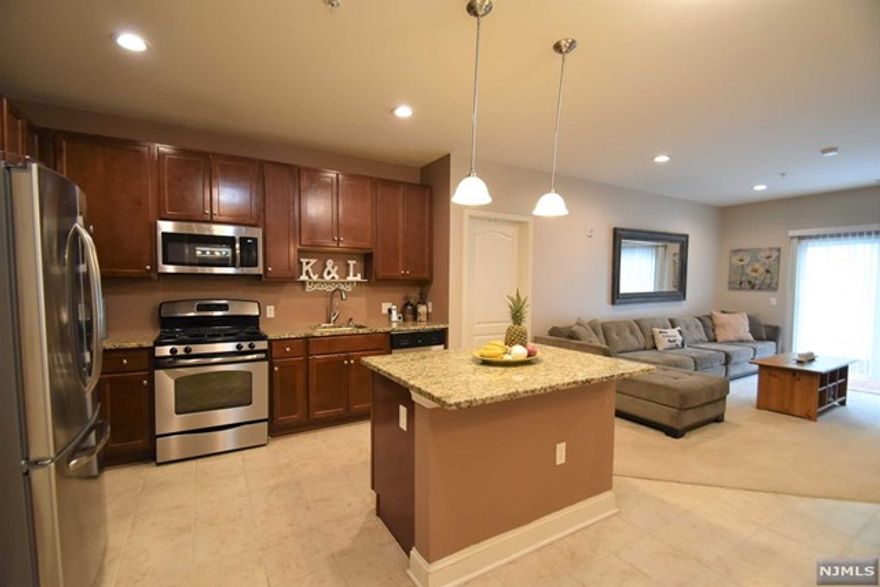 INT PICS COMING SOON! LIVE THE GRANDE LIFE! Very rare, absolutely beautiful 1,232 s.f. Laurel Model! Featuring bigger kitchen with SS appliances & center island. Nice size living room & dining area. This is one of the rare 2nd flr models that allows hardwood flrs throughout! Two generous size bedrooms with WIC. Each bedroom can be used as a master bdrm w/own bath! Full size W/D. Terrace off of living rm. Nice size laundry rm with side by side W/D. One car garage assigned space underneath bldg. Add'l parking outside. Amazing low Riverdale taxes only $5525. Enjoy all the amenities, 2 clubhouses, 2 pools, tennis courts, bocce ball, fitness ctr, billiards rm, conference rms, party rms & much more. Near all major highways, shopping & restaurants! PET POLICY- MAX 2 PETS PER CONDO -35LB WEIGHT LIMIT PER PET.