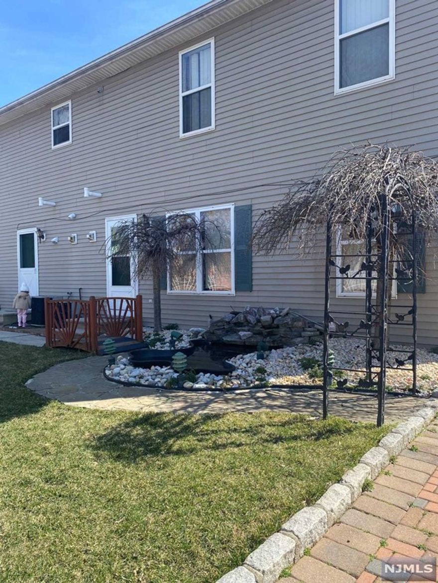 Welcome home! Located on a large corner lot & quiet residential street, this newly renovated 2 bed, 1 bath apartment has everything you can possibly imagine, & more! Private entry, brand new cabinetry, stainless steel appliances, laminate wood-flooring, fresh paint & laundry in-unit! Grab a cup of coffee from the deli nearby & enjoy the patio right outside of your doorstep with a beautifully landscaped yard, small pond & smoke grill. The fenced in park across the street offers great space for play! Private off-street parking is negotiable. A few blocks away from Main Street, local shops & restaurants, schools & blocks away from NJ transit- which gets you to Penn station in 30-35 minutes. Will go quickly, schedule your showing now.