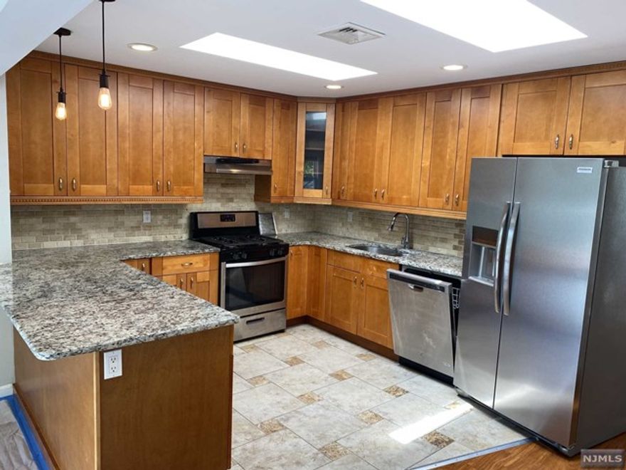 Totally renovated 2nd floor apartment 3 bedrooms, 1 full bath. Hardwood floors throughout, updated kitchen with granite counter tops and SS appliances, central A/C!