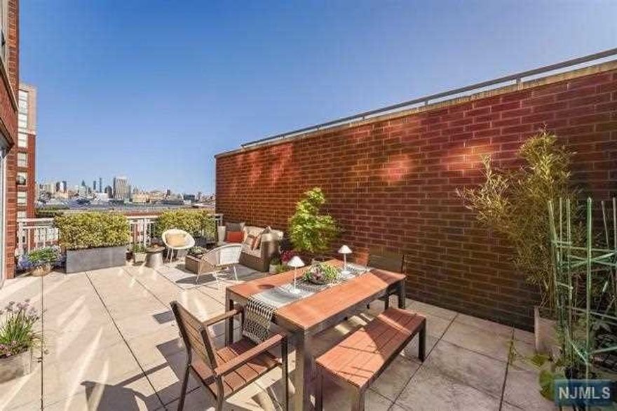 The stunning and expansive terrace with exceptional NYC and Hudson River views is the icing on the cake of this fabulous light-filled 1500+ sf, 2 bed/ 2.5 bath home at the very desirable Maxwell Place. This residence offers the perfect retreat for relaxing and entertaining. From the wall of east facing windows in the living room to the broad south facing windows throughout, this home is drenched in wonderful natural light! An airy, oversized open floor plan accommodates both living and dining areas, and includes a custom built-in bar with a Sub-Zero wine refrigerator and additional storage. A well-appointed kitchen equipped with stainless steel appliances and an abundance of cabinets offers plenty of counter space for cooking, meal prep and seating, too! The primary bedroom is massive and overlooks the terrace, offering two closets and a spacious bathroom. The large second bedroom has an en-suite bathroom as well and a substantial walk-in closet.