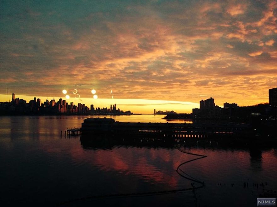 Riverfront living at it's finest! Gorgeous, 1614 sq ft 2br 2bth unit facing south and east. Magnificent NYC and water views. Walls of sun filled windows. 3 balconies. Large open kitchen with granite counter tops and breakfast bar, stainless steel appliances, cherry cabinets. Laundry in the unit. Parking. Excellent location - walk to retail stores, restaurants, movie theatre, bus stop and more.