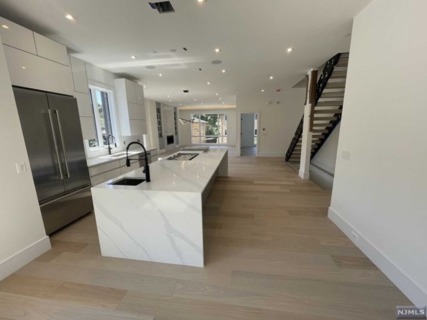 Welcome to 10 Hooks Lane, A Modern Contemporary Design Townhouse Encompasses A Sleek Exterior Design with Black Brick, Aluminum Clad Bump-Outs, Oversized Anderson Windows, and Black Aluminum Glass Doors....Approximately 4200 Sq Ft over 4 Stories with Glass Enclosed Rooftop Deck with NYC and Hudson River Views....Open Concept on Main Level with 10ft Ceilings, European Style Kitchen with Oversized Island, Living Room with Cove Lighting and Linear Gas Fireplace, Home Office, Dining Room, and Trex Deck....Primary Suite with Walk In Closet and Spa Like Bath, Two Additional Well Appointed Bedrooms with Full Bathroom in Hallway....Loft complete with Wet Bar and Half Bath with Sliding Doors opening out to Rooftop Deck....Ground Level with 2 Car Garage, Recreation Room, Bedroom/Office, Half Bath....Additional Features Include Private Elevator, White Oak Floors, Multi Zone HVAC, Camera Ready, Multi Zone Speaker System, Smart Home Ready....