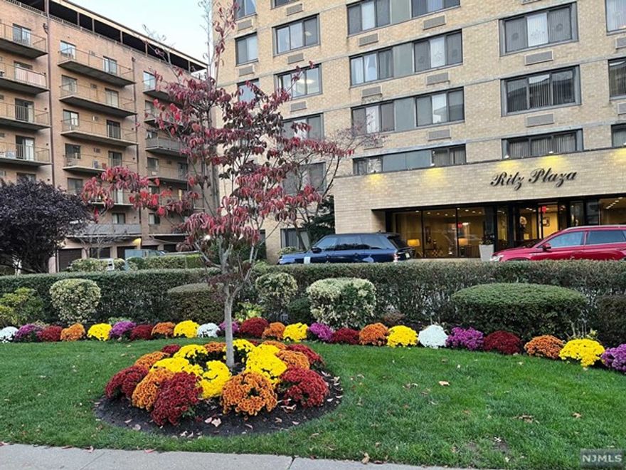 This is it! Oversized (1350 sq. feet) of updated kitchen and baths! A commuter's dream - bus stop across the street to Port authority and 2 train stations to the PATH. Entry foyer leads to living room and terrace. Kitchen is updated and has a breakfast counter. Open concept to dining area with view of Ft. Lee and GW Bridge. Primary bedroom has two closets and en-suite bath w shower. Second bedroom is good sized. Second hall bath w shower. Amenities include 24 hour doorman and security, one garage space #98, hot water, super on premises, basic cable, and a full gym. Close to parks, schools, shopping malls, Hackensack hospital and major highways. Come enjoy the new shops and restaurants on Main Street and the new entertainment center HACPAC. Buyer pays 2 X maintenance capital contribution + 200 MVIN, REFUNDABLE DAMAGE DEPOSIT $500, +250 TF. Must be owner occupied for first two years!