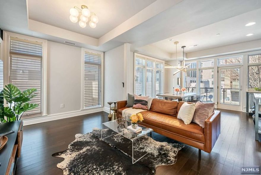 Sensibly designed and sitting in a terrific neighborhood, 8 Cambridge Way is now available. Townhomes such as this one are quite special, as not many exist in this coveted location. Plus, the wonderful smart home is an end unit, which allows for more windows and lots of natural light. All four floors of living space comfortably achieve their purpose. A wall was removed between the kitchen and living room to create an open space. The kitchen is equipped with custom cabinets, Perla Venata quartzite countertops, and Hunter Douglass shades. Every bedroom is en suite. The primary suite's two closets are designed by California Closets. Multiple cars fit in your garage. The elevator is awesomely useful. And the rooftop deck is perfect to entertain or lounge while overlooking New York City's newest neighborhood, Hudson Yards.