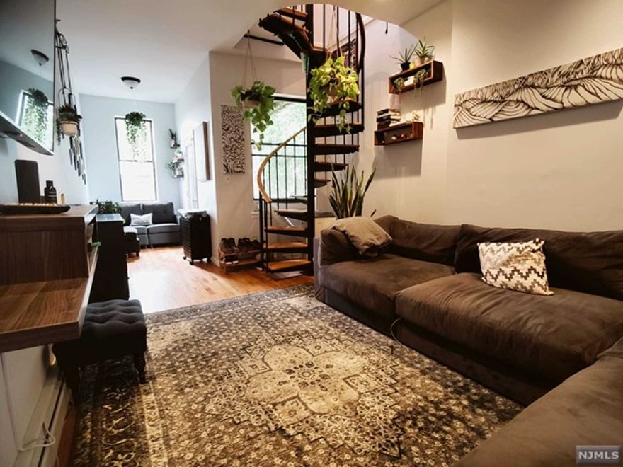 Welcome to your dream home in the heart of Jersey City! This stunning top floor duplex (2 floors of living space) offers the perfect blend of luxury, convenience, and breathtaking views. With its sun-drenched interior, two expansive balconies, private roof storage, bathrooms on every floor, all located in prime location just blocks away from the Grove Street PATH station 6 minutes into NYC. As you step into this sunny duplex, you'll be greeted by the soaring 9.5' ceilings that create an open and airy ambiance. The first floor boasts hardwood floors, adding a touch of warmth and elegance to the living space. Prepare delicious meals in the gourmet kitchen featuring a granite breakfast bar and countertops, stainless steel GE appliances, and beautiful mahogany cabinets. The living area seamlessly flows onto not one, but two large private balconies where you can soak in panoramic views of the Statue of Liberty, the iconic NYC skyline, Downtown JC, and JC City Hall.