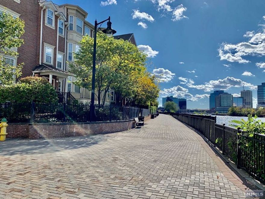 13 year old townhome. Brewster Model (1,340 sf) with 1 covered parking space. Central air. 9'ceiling on lower level. Living Rm: 14'2x18'6, Dining Rm: 10'3x11'1, Eat-in Kitchen: 11'2x11'6, Bedrooms: 14'2x11'2 & 16'2x14'. Hardwood floors throughout both levels. Quartz countertop in kitchen and baths. Recessed lighting in bedrooms and living room. Walk to Harrison Path Station in 12-15 minutes. No pets, no loud music & no smoking in apartment. Good credit required. True River Front unit with panoramic river view from most of the rooms. Gym, Swimming pool & clubhouse usage included. Flood insurance covered by condo HOA fees. Available to occupy on July 1st. Tenant to pay $150 move-in fee & 200 refundable moving deposit required by the condo management. 1.5 month security deposit. One-month Broker's commission to be split between the landlord and the tenant. Each pays a half. Attached photos taken two years ago.