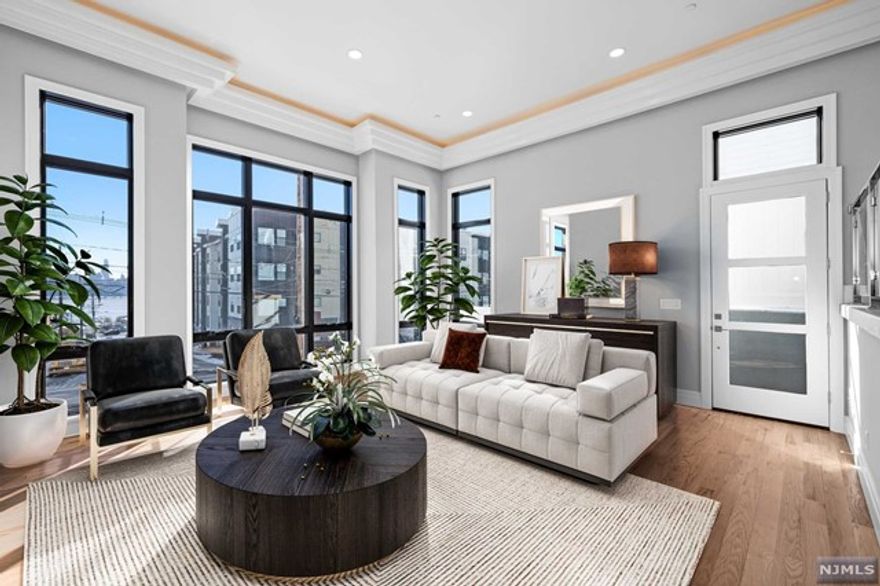 A haven in the heart of Edgewater! Filled with natural light, this 21-foot wide 4 Bed 3 full & 2 half Bath townhome offers breathtaking NYC views throughout. You'll feel right at home in the spacious main living room with its soaring 14-foot high ceilings. The eat-in kitchen is a chef's delight, featuring quartz counters and top-notch Thermador appliances as well as a separate bar and formal dining area. Retreat to your personal sanctuary - the primary bedroom. Spa bath with a dual vanity, lavish shower, luxurious soaking tub and 2 closets await. 2 additional bedrooms, full bath and laundry complete the 2nd floor. The top floor family room and roof deck are the perfect backdrop for taking in the NYC & Hudson River views. An additional bedroom, wet bar and full bath make this a perfect space for guests or a home office. Oversized 2 car garage, additional driveway parking, in-home elevator, super private rear patio & more! IDEAL location w/ NYC bus, schools & shopping @ end of block