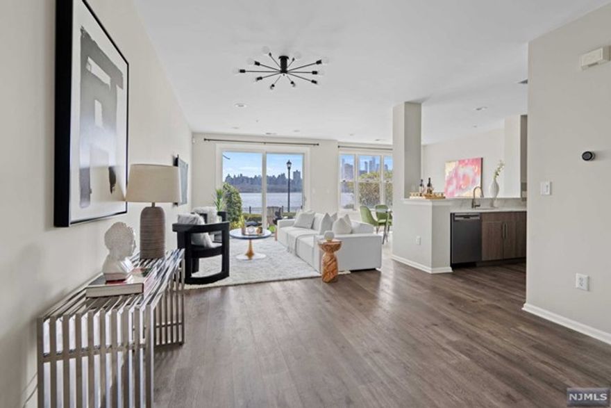 Experience pure luxury w/ this FULLY RENOVATED townhome w/ DIRECT EAST VIEWS of NYC & the Hudson River! An impeccable Bergen style, this 2BR/2.5BA home spans across 1,444 SqFt & features top-of-the-line finishes including gleaming hardwood floors throughout. The updated Chef's kitchen opens to the main living/dining area & features SS appliances, quartz countertops, a breakfast bar, & plenty of cabinet space. Step outside onto your private patio to make indoor/outdoor entertainment easy! Make your way to the 2nd floor to the large primary ensuite featuring a customized walk-in closet, a balcony w/ direct NYC/River views, & an ensuite modern bathroom w/ double vanities & one large walk-in shower. Generous size 2nd bedroom w/ a full bath & extra storage in the hall. Enjoy the fully customized laundry room & parking for 2 cars to complete the home! Jacobs & Bulls Ferry includes 24-hour security, shuttle to/from Ferry & Lightrail, 2 outdoor swimming pools w/ Jacuzzi, & more!