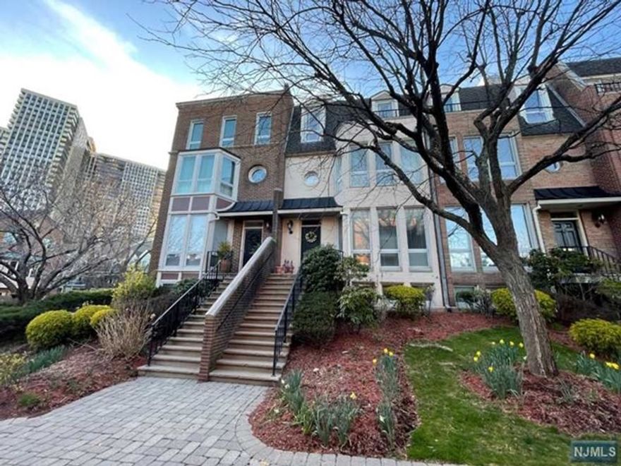 Beautifully renovated unit located in the gated community of 4 story townhouse. This unit offers an open layout design and all 4" Oak hardwood floor throughout. The 1st Floor features a living room w/a wood burning fireplace, gourmet kitchen outfitted w/gorgeous custom cabinetry and granite countertops,island & breakfast area;a dining room & a deck. 2nd floor features a large M/bedroom suite w/walk-in closets,a dressing rm,spa-like M/bath & an additional en suite bedroom; on the 4th level find 2 additional bedrooms with a full uniquely designed bathroom giving each bedroom their own powder room. A private elevator to all levels. A deck with a gas connection. Attached 2car garage w/2car driveway. 24hr attended gatehouse and Outdoor pool. *** Owner is motivated to sell it to qualified buyers. ***