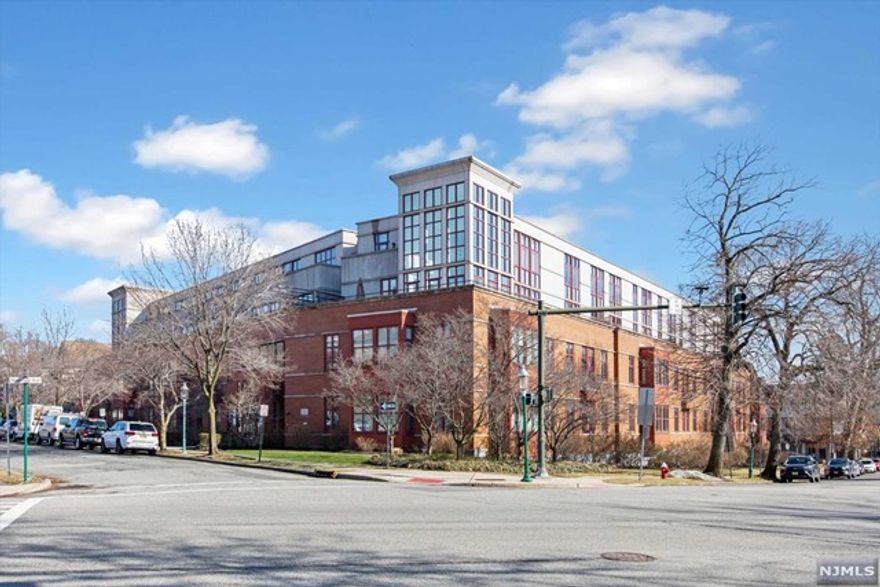 What A Wow! This is the largest end unit in The Reserve with 2 terraces, high ceilings, a wood-burning fireplace, custom closets and sunshine galore through the floor to ceiling windows. The spacious living/dining room area is open to the big fabulous kitchen with quartz counters, under counter sink, custom cabinetry & high-end appliances. The large entry foyer includes a powder room and custom closet with built-ins. The large bedroom opens to a private terrace & also features floor to ceiling windows, custom closets plus a walk-in closet. A stones throw from MidTown Direct train service at Glen Ridge Station, along with bus service, Starbucks and more on Bloomfield Avenue. Two parking spaces in the underground, heated garage plus a storage area. Building amenities include concierge services, courtyard and clubhouse, and a fitness center. Property Assessment Reduction resulting in reduced taxes effective in 2022.