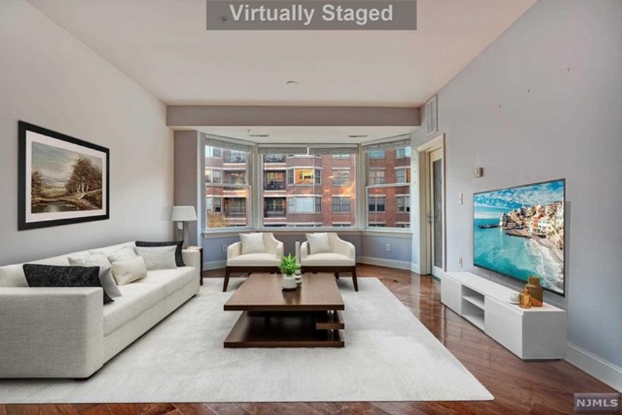 Welcome to this South-facing 2 Bedroom, 2 Bathroom home with views of NYC and the Hudson River located in Grandview II. This sun-drenched unit stretches across 1,273 SqFt and is flooded with natural light. Featuring hardwood floors throughout, a south-facing balcony, in-unit washer/dryer, one car garage parking, and plenty more! The open kitchen features granite countertops, stainless steel appliances, and an island perfect for your daily needs. The master bedroom includes a walk-in closet and ensuite bathroom with a double vanity and jacuzzi tub. The Grandview II community includes a 24-hour concierge, fitness center, an outdoor swimming pool, resident lounge, shuttle to/from Ferry and Light Rail, restaurants, shops, and grocery store directly across the street, along with ease of access to NYC. A gem of a home awaits you!