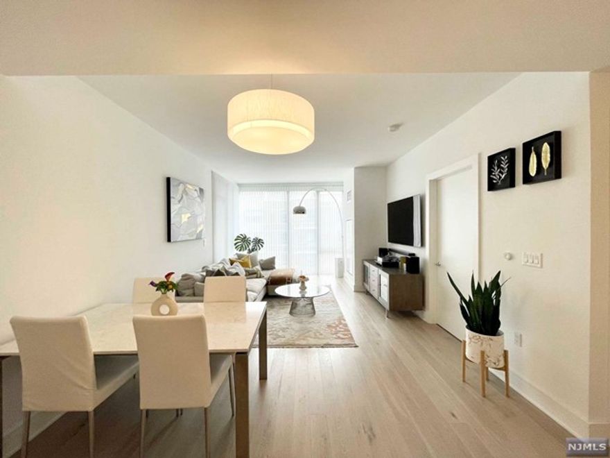 Discover pure modern elegance in the most premier & luxurious new construction building, Nine on The Hudson, located along the desirable NJ Gold Coast waterfront. Spacious 2BR/2BA open floor plan covering approx. 1,140sf with SOUTHERN exposure & partial NYC views from the balcony. The expansive kitchen includes Aspen quartz countertops, Pedini cabinets, Bosch appliances, & Thermador refrigerator. Large master ensuite w/a custom WIC & generous size 2nd BR. Enjoy wood flooring throughout, Bosch in-unit W/D, oversized windows equipped w/ Hunter Douglas electronic shades, medium-sized storage unit & 1-car garage parking. This beautifully designed luxury building features breathtaking views of NYC with 40,000 sqft of resort-style amenities: 24-hour doorman, fitness center, amenity deck with infinity pool & BBQ area, rooftop deck with cabanas, lounging areas, pet grooming facility, children's playroom, virtual golf, & a quick commute to NYC via shuttle to/from Ferry or bus!