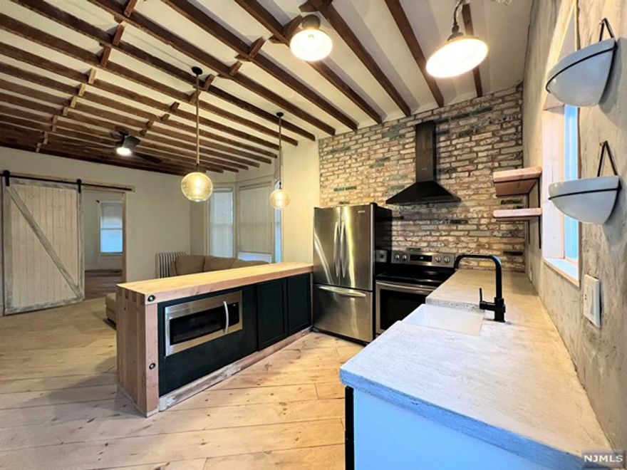 Designed to Impress & Entertain! This Oversized unit is One-of-a Kind; w/its own Private Entrance & Open Floor Plan. 12 ft ceilings, 8 ft kitchen island, Wide Plank Hardwood floors, built-in custom millwork shelving, custom reclaimed brick throughout, new S/S appliances, Washer/Dryer, & much more. The Builder uses a variety of reclaimed wood & brick to create a "Modern Industrial Farmhouse" feel that is both Captivating & Practical. Bonuses--Outdoor Deck, use of Yard & Pet Friendly! On a quiet block in the desirable Protected Historic Community of the Forest Hill section-next to Branch Brook Park. ONE BLOCK FROM BUS/NYC. 3 BLOCKS FROM TRAIN/NYC. ALL UTILITIES INCLUDED!!! Pets Conditional - Small Dog OK.