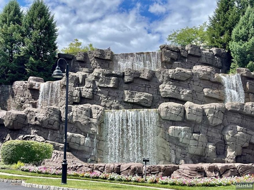 Welcome to Four Seasons at Great Notch! Beautiful 55+ Gated Community only 12 miles west of NYC. Gorgeous 2nd floor, 2 bedroom, 2 bath Zinnia model with 1765 s.f. of elegance. Features include an elegant living room with gas fireplace, formal dining room & a spacious office. The kitchen has a large two tier center island with a separate dining area and doorway to a relaxing balcony. The primary bedroom suite offers 2 WICs, Primary Bath with jetted tub, shower stall and double vanity. The second bedroom is also spacious with plenty of closet space. There is a private. one car, attached Garage and a Storage Room. This Community features 25,000 sq ft Club House with a Multipurpose Rm, indoor and outdoor pools, Tennis Courts, Fitness Center, Putting Green, and Pickleball. There is also a Library, Cards Room, Bocce Ball Court, Mahjong Club, Sauna, and Billiards Room. Club House has benches where you can relax and enjoy an amazing view of the New York Skyline.