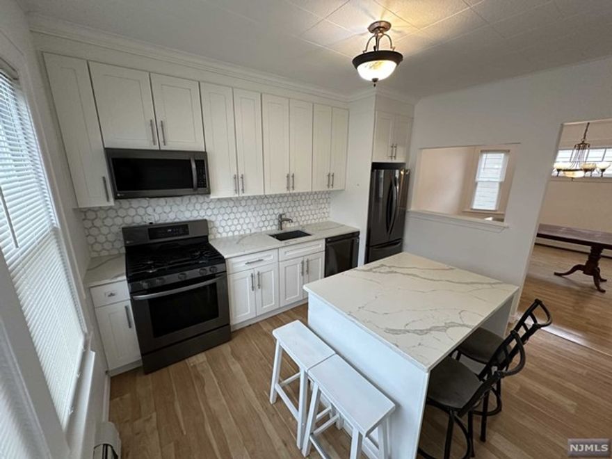 WELCOME TO THIS GRAND SECOND FLOOR APARTMENT. APARTMENT FEATURES 3 BEDROOMS, 2 FULL BATHROOMS AND A LARGE FULLY FINISHED ATTIC CONTAINING A GOOD AMOUNT OF SPACE. NEWLY RENOVATED KITCHEN WITH ISLAND SURROUNDED BY BEAUTIFUL QUARTZ COUNTERTOPS, STAINLESS STEEL APPLIANCES WITH A GREAT QUALITY BACKSPLASH. UNIT HAS BOTH INCREDIBLY SPACIOUS LIVING AND DINING ROOMS. BESIDES 3 BEDROOMS, THERE IS ALSO A SMALL EXTRA ROOM THAT COULD BE UTILIZED AS A SPARE CLOSET OR OFFICE. HARDWOOD FLOOR THROUGHOUT THE APARTMENT. AND NICLEY FINISHED BATHROOMS, AND FRESHLY PAINTED ENTIRE UNIT. ALONG WITH 2 OUTDOOR PARKING SPACES, THIS UNIT HAS LOTS OF POTENTIAL AND PLENTY OF ROOM TO ENTERTAIN GUESTS.WASHER AND DRYER INCLUDED. CLOSE TO TRANSPORTATION, SCHOOLS, PARKS, AND SHOPPING CENTERS. TRULY MUST SEE IT TO APPRECIATE IT.