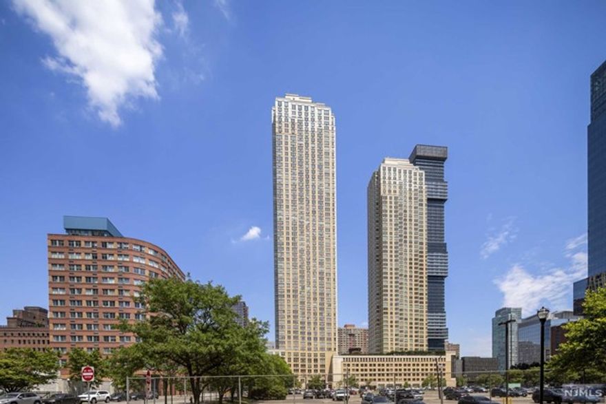 Come home to the breathtaking views of Midtown Manhattan in your 2 bedroom 2 bath condo at the Luxurious Trump Plaza Residences. Blocks from The Grove Street and Exchange Place Path Stations and Ferry Service to NYC, the building is centrally located for easy commute and in close proximity to all that Jersey City has to offer. The unit features Stainless Steel appliances, granite countertops, hard wood floors, and tons of closet space. The amenities include Full Service Gym with classes, Aqua grotto spa, steam room, sauna, Kids Play room, Ping Pong room and much more.