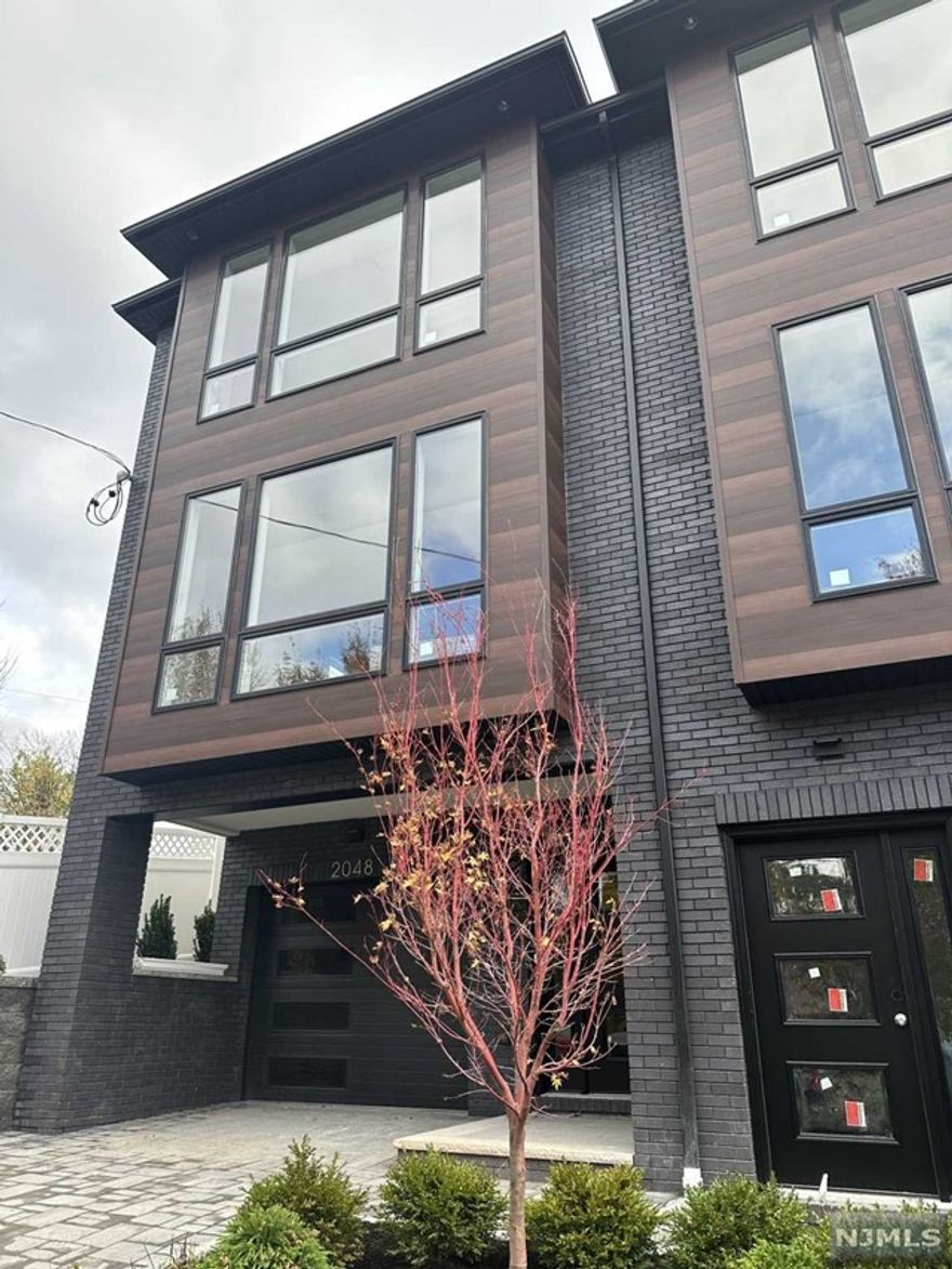 In famous Fort Lee, a must see duplex style condo. Newly constructed. Location is just a short walk to the fabulous Constitution Park, shopping, restaurants, cafes, entertainment & GWBridge. Approx. 2200 Sq. Ft. of elegant living plus landscaped outdoor space. Exquisite finishes, 3 levels of living include a welcoming entrance foyer, finished ground level rec room and garage. 2nd floor: Living Room with Gas FP and quartz enclosure, central kitchen with oversized island, dining area open floor plan, beautiful natural light, floor to ceiling windows, recessed ceiling speakers, quartz countertops, stainless steel appliance package, oak wood floors, 9' ceilings, sliders to patio perfect for your bbq. Upper floor houses the primary suite, two bedrooms, exquisite full bath, washer and dryer, ample closets and oversized windows. Additional features: LED recessed lighting, exterior BBQ gas line, underground sprinkler system, paver driveway. A place you can proudly call home.