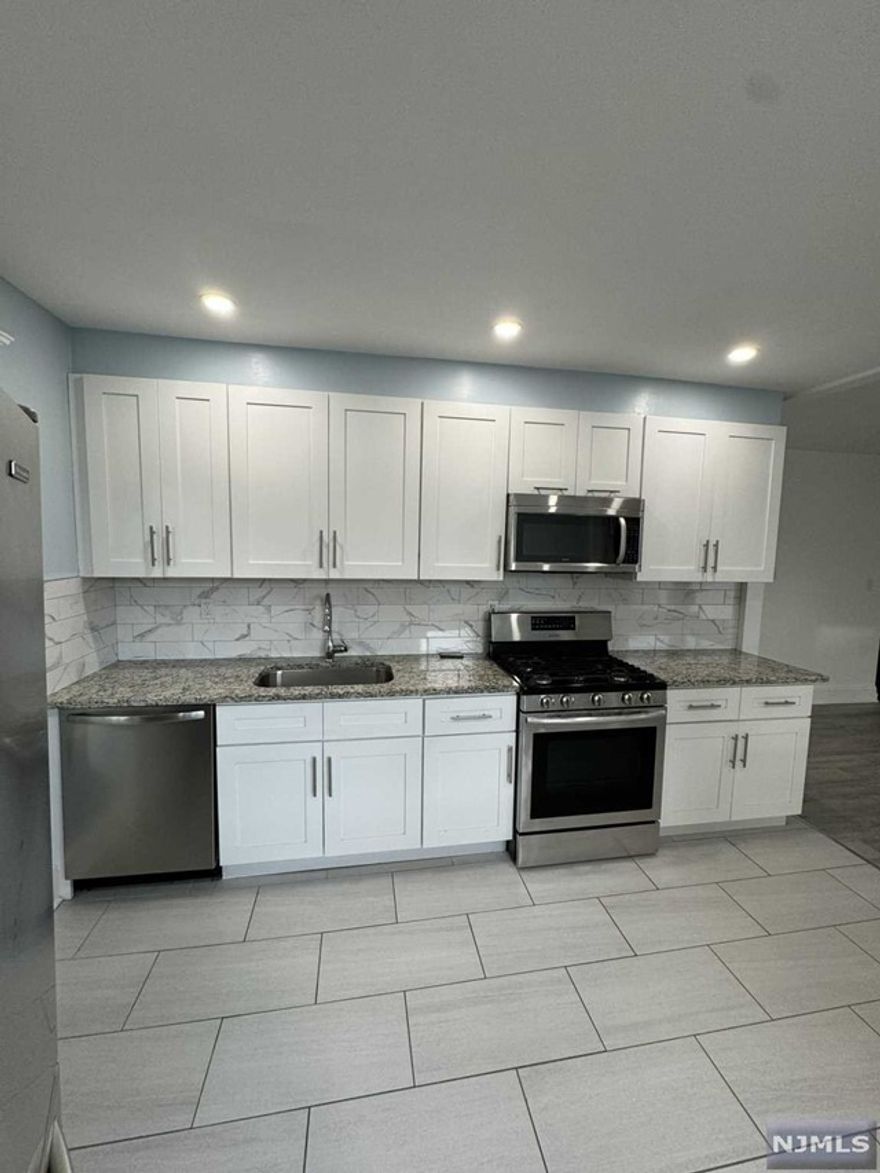 Welcome to your new home! This beautifully updated 2-bedroom apartment features an open-concept kitchen equipped with granite countertops, a dishwasher, and sleek stainless steel appliances. Enjoy abundant natural light throughout the space and relax in the modern, renovated bathroom. With a bonus attic space perfect for storage, this apartment combines style and functionality. Conveniently located just steps from Main Street, you'll have easy access to direct public transportation to NYC, major highways, and a variety of shops, restaurants, and services. Heat and hot water included. Don't miss this incredible opportunity! Schedule your private showing today. Plus, rest easy knowing the property is not in a flood zone. Your dream home awaits!