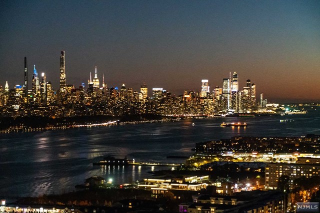 LUXURY PREMIER PENTHOUSE DUPLEX WITH WRAP AROUND TERRACE & WALLS OF WINDOWS THAT OFFER VIEWS OF GWB, MANHATTAN SKY LINE DOWN TO THE STATUE OF LIBERTY.NATURAL LIGHTING THROUGHOUT THE ENTIRE APARTMENT. THIS SPECTACULAR PENTHOUSE HAS BEEN ARCHITECTURALLY REDESIGNED WITH OPEN FLOOR PLAN, MARBLE FLOORS, AND GRANITE THROUGH OUT, 2 BURNING WOOD FPL, CUSTOM BUILT IN UNIT ELEVATOR,CUSTUM STAIRWELL, CUSTOM CLOSETS, SMART COMMAND CENTER, TOP OF LINE APPLIANCES, NEW HEATING/COOLING SYSTEM, WINE TASTING ROOM, BUILT IN BAR. FEATURES WITH 4 BEDROOMS, EN-SUITE LUXURIOUS MARBLE BATHROOMS AND WALLK IN CLOSET FOR THE PRIMARY BEDROOM. OFFERS FULL AMENITIES & EASY TO COMMUTE TO NY, CLOSE TO SHOPPING, RESTAURANTS, SCHOOLS AND MUCH MORE!