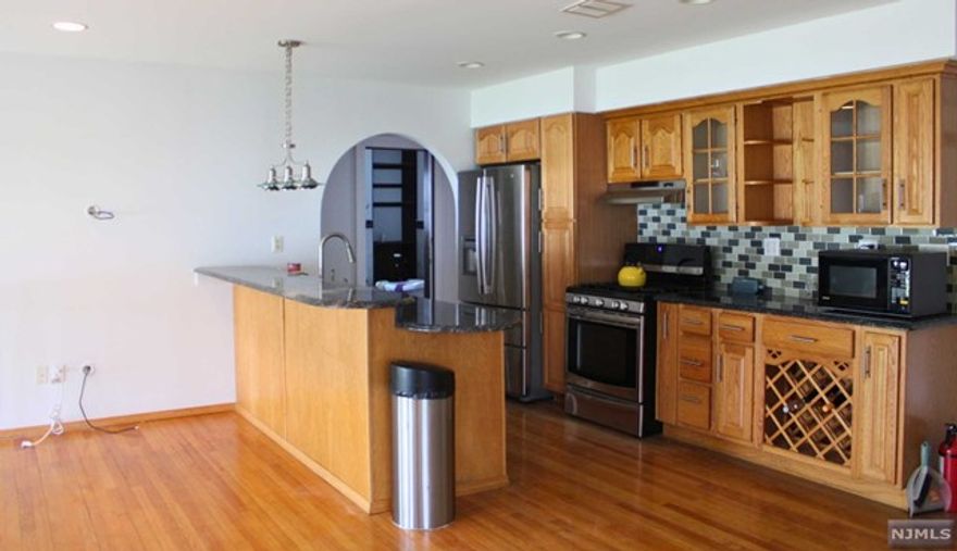 This house is not a quick "drive-by"; you truly need to see the open floor plan as well as the incredible renovation work done. Inside, you'll find a space seamlessly integrating a stunning kitchen, living rm, family rm, and sitting area. This property boasts three bedrooms, two full bathrooms, a cozy living room, and a formal dining area. A fireplace adorns the family room adjacent to the dining room, while a serene sitting area offers views of the patio and backyard. Finished basement. 1 car attached garage. EZ commute to NYC, Route 3, Route 21, Garden State P'way, Route 17 and Route 46. Near NYC Transportation.