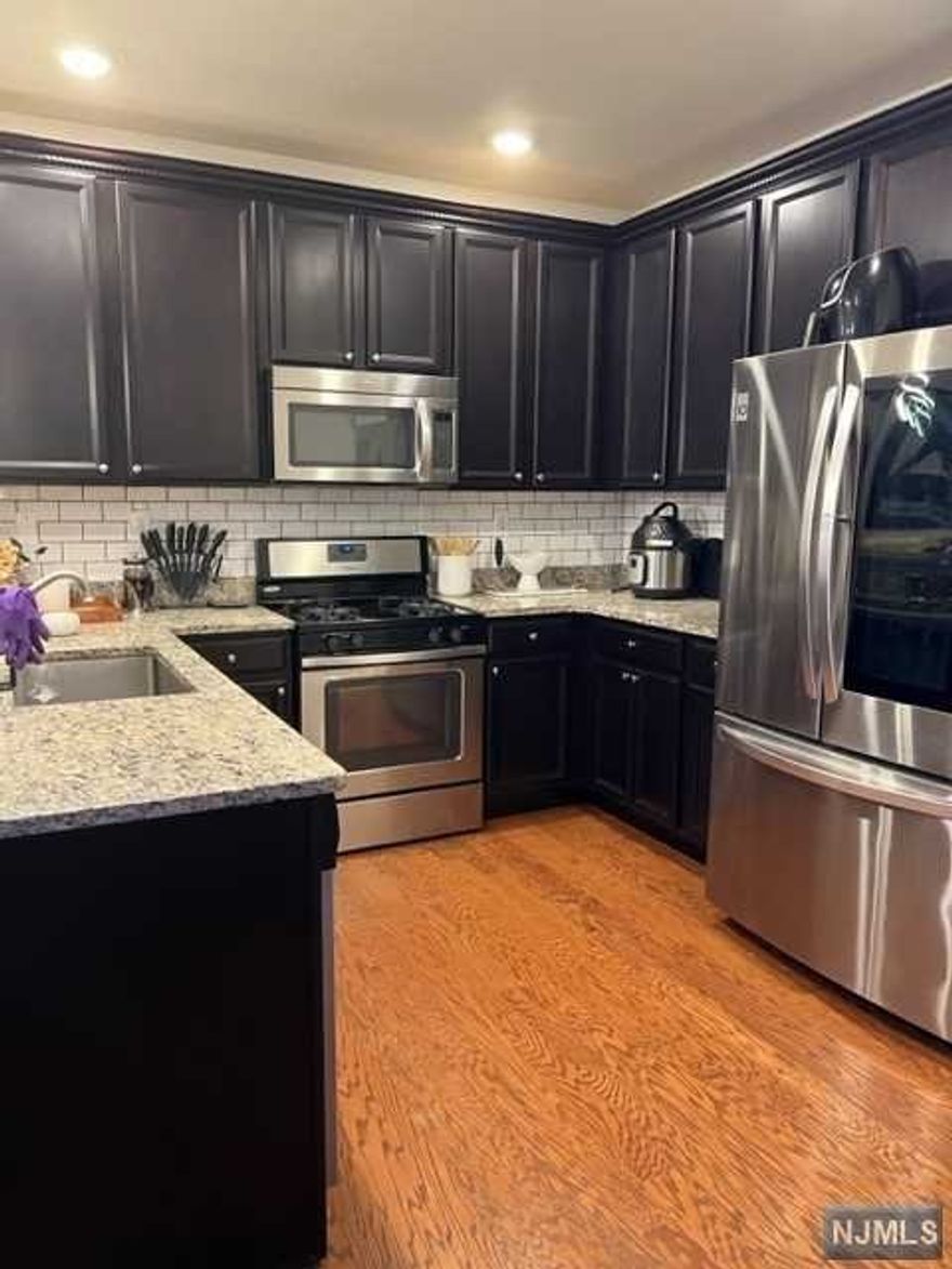 Newly developed Signature Place At Garfield with a clubhouse, gym and outdoor pool. Near Elmwood Park border. 1 car garage plus an additional parking space with keyless entry. Maple cabinets and granite counter-tops in kitchen & baths. Recessed lighting in kitchen, loft and master bedroom. Hardwood floors on 1st level. W/W carpeting on 2nd level. Close to all major highways, shopping, entertainment & dining. Only 12 miles from NYC & with buses/trains minutes away.