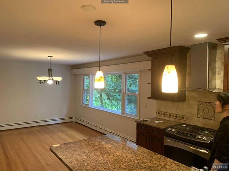 his updated and expanded Split Level featuring a newer eat in kitchen with granite counter and island, and stainless steel appliances, an elegant living-room , large family-room. Master bedroom suite with balcony and luxuary master bath with skylight. Other features include full basement, brand new paved parkway, multi-zone gas/hw heat, upgraded electric, new roof, siding and more. Walk to schools and public transportation. The house faced south.