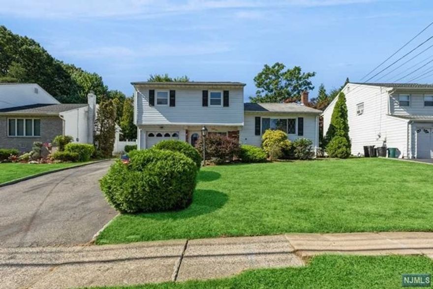 Beautiful 3 bedroom 1.5 bath split level home. Renovated throughout and move in ready. First floor features an open floor plan with new kitchen cabinets with corian counter tops, and stainless steel appliances. Sliding door to a sunroom overlooking the spacious fenced in backyard. Hardwood and woodgrain laminate floors throughout. Basement level features a family room and utility room with laundry area. Ground level includes 1 car attached garage for easy entry to home. Convenient commute to NYC via train/bus and easy access to major highways.