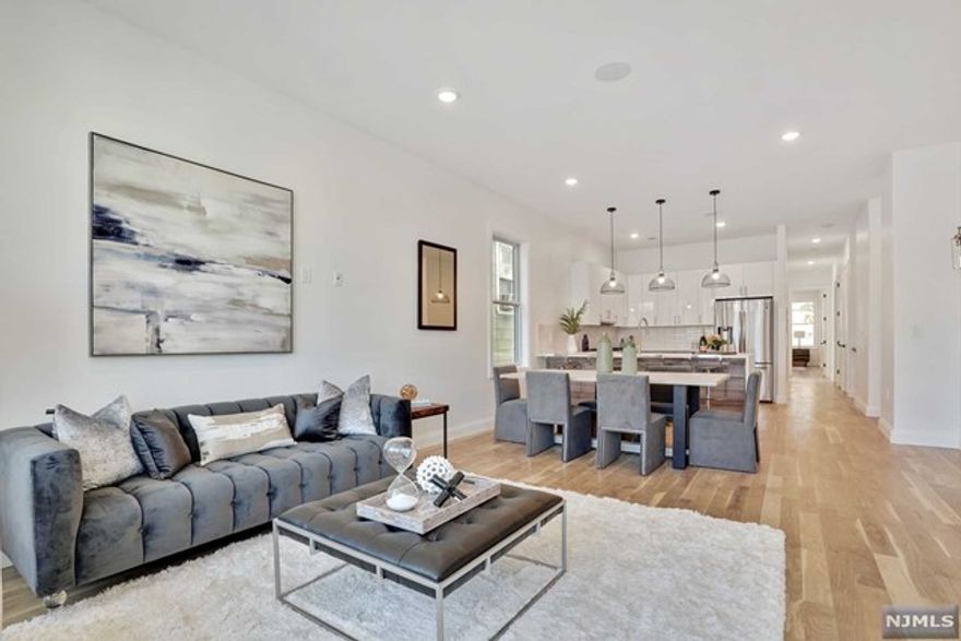 Enjoy breathtaking views atop your private roof deck residence at the luxurious and one-of-a-kind 197 Arlington Avenue. This newly constructed 3 bedroom, 2 bath condominium with garage parking is sure to impress. Thoughtful attention to detail throughout, with beautiful oak wood flooring, 10 ft ceilings, oversized windows, custom storage closets and built-in surround sound. The exquisitely designed kitchen features an Italian tile backsplash, modern two-tone cabinetry, quartz countertops with waterfall peninsula, XL pantry closet and stainless-steel appliances. The main level offers a full bath, large laundry closet, two generous-sized bedrooms and primary bedroom suite featuring a sleek en-suite bath with custom walk-in closet. A stunning floating staircase leads to the large private roof deck, with beautiful views of NYC, the Statue of Liberty and Freedom Tower. Prime location in Bergen/Lafayette near Berry Lane Park, the Garfield Light Rail station, local shops and restaurants.