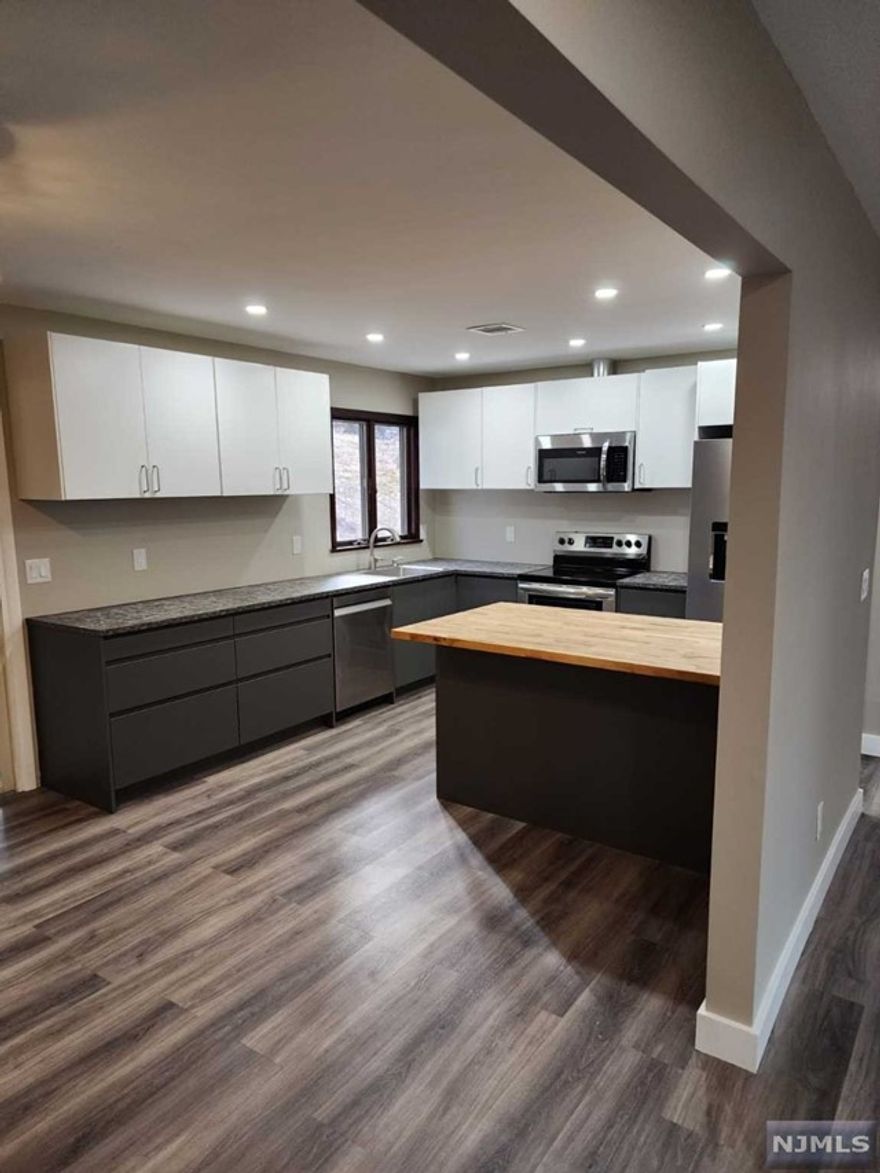 Welcome to 19 Juniper Terrace in Ringwood, NJ! This elegant, classy & newly renovated four bedroom/three bathroom home is a gem you won't want to miss! This bi-level is sleek and modern from head to toe. Enter into the foyer, and walk upstairs to the living & dining area. Grey vinyl floors run throughout the home providing a cohesive look. The kitchen is crisp and open, complete with chic two-tone cabinets. The screened porch is accessible through sliders off the dining room. Down the hall you will find 3 bedrooms and 2 bathrooms, all spacious and updated, as is the lower level of the home. The den features a beautiful glass door which lead to the backyard. Also downstairs is a bedroom, bathroom & laundry room! If you are looking for a move in ready, spacious & modern home to rent, this is the one for you! WILL NOT LAST!