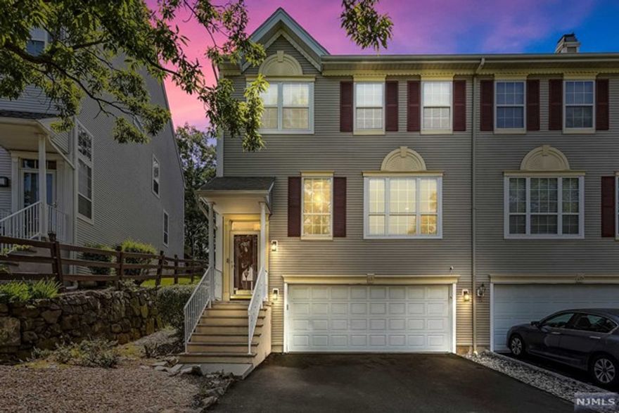 Luxurious Stone Bridge townhome nestled in the tranquil & esteemed neighborhood of Wayne. Every detail from the high end fixtures to the premium finishes has been thoughtfully selected creating an aura of sophistication. Main level boasts an inviting open floor plan adjoining the living & dining rooms. Brand New Wood floors throughout the unit. The gourmet kitchen is a chef's paradise, featuring top-of-the-line appliances, custom cabinets' w/pantry, breakfast bar & a large center island. The kitchen opens up to the family room featuring a wood burning fireplace & soaring ceilings that allow natural light to pour in. Luxurious primary suite offers vaulted ceilings, walk in closet, oversized spa-like shower, separate make-up area & a skylight. The rest of the 2nd floor consists of 2 bedrooms, full bath & pull down attic. Ground level boasts a spacious recreation room/ home office & 2 car garage. Private paver patio offers serene views of the woods.