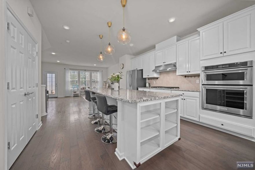 Welcome to Liberty Square at Westmont Station in Wood Ridge, NJ! This stunning 3-story, 3 bedroom, 2.5 bathroom townhouse offers a modern, spacious, and open-concept layout. Enter on the ground level into the foyer, leading into the den/ office space, and access to the 2 car garage. Head on up the stairs to a large living room, dining area, and gourmet kitchen with a huge center island. The kitchen boasts stainless steel appliances and a separate desk nook. Huge private terrace, perfect for outdoor entertaining and enjoying a bit of the outdoors. The top floor has three generous bedrooms and two full bathrooms, with the primary bedroom having an en suite. Laundry on this top level for your convenience! This incredible townhouse is pet-friendly and has it all! Liberty Square at Westmont Station offers EASY COMMUTING OPTIONS into NYC and easy access to all major highways. DO NOT MISS !