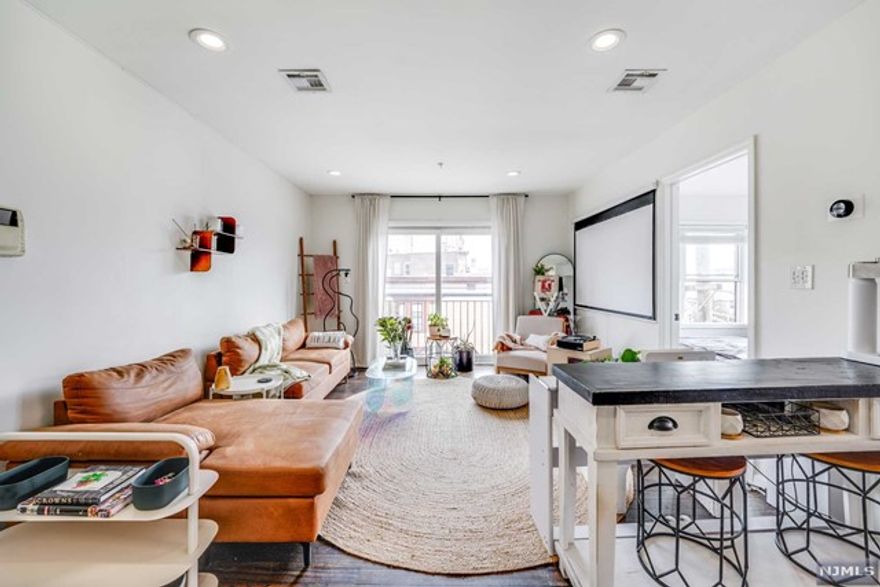 Situated in a highly desirable location, just a few blocks away from the Hudson Light Rail Station, this modern, renovated corner unit offers a perfect blend of style, comfort, and convenience - plus 2 deeded parking spots! Meticulously maintained with a bright and spacious floor plan, hardwood floors throughout, stainless steel appliances, and eastern exposure with a view of the NYC skyline. Low HOA and taxes make this a true urban gem.