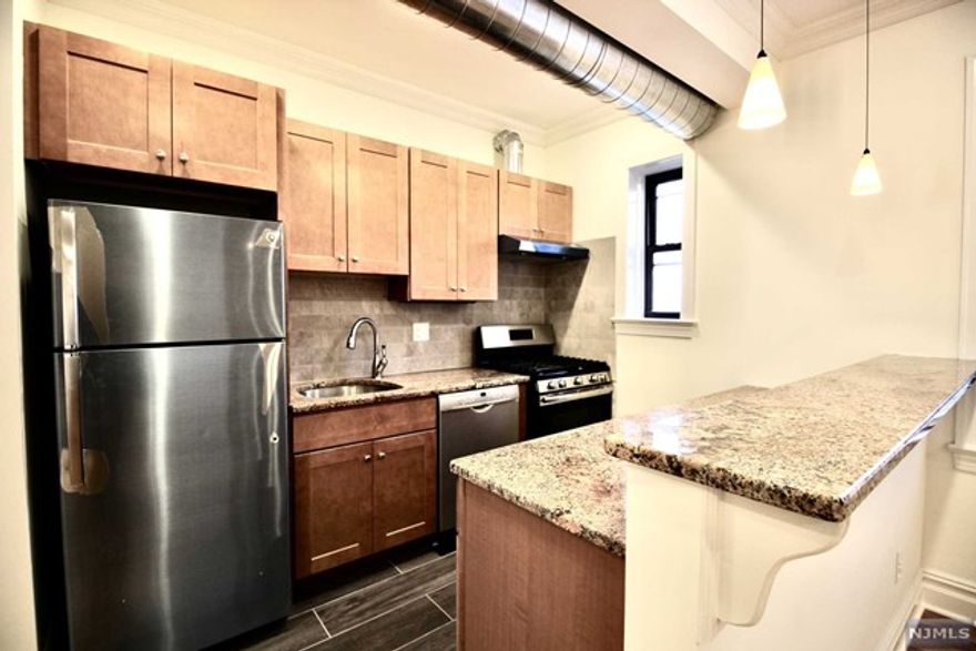 PACK YOUR BAGS & MOVE INTO THIS LARGE & UNIQUE INDUSTRIAL STYLE 1 BDROOM APT. BEAUTIFULLY RENOVATED WITH ALL THE MODERN CONVENIENCES, IT IS COMBINED WITH THE ELEGANCE OF A HISTORICAL ART DECO BUILDING. THE APARTMENT BOASTS UPSCALE FEATURES & FINISHES SUCH AS CENTRAL HVAC; OPEN DUCTWORK; SLEEK KITCHEN WITH S/S APPLIANCES (INCL. BOSCH DISHWASHER); GRANITE COUNTERS WITH BREAKFAST BAR; SOLID WOOD MAPLE SOFT CLOSE CABINETS. GORGEOUS WIDE PLANK HARDWOOD FLOORS; CROWN & BASE MOLDING; HIGH CEILINGS; RECESSED LIGHTING; CEILING FANS; WINDOW TREATMENTS; TILED BATH WITH VANITY SINK; BUILT-IN WOOD CABINETS & SHELVING AND EXTRA SOUNDPROOFING. LAUNDRY IN BRIGHT RENOVATED BASEMENT. STREET PARKING BUT EASY TO FIND SPACES. NO PETS PLEASE!! BORDERING ON PALISADES PARK, IT IS CLOSE TO ALL HIGHWAYS & SHOPPING. BUS TO NYC RIGHT OUTSIDE. IT'S THE TALK OF THE AREA--GREAT SPACE AT A GREAT RENT! IT'S NOT YOUR COOKIE CUTTER APARTMENT!!! MAPLE GARDENS IS A SMOKE-FREE BUILDING!