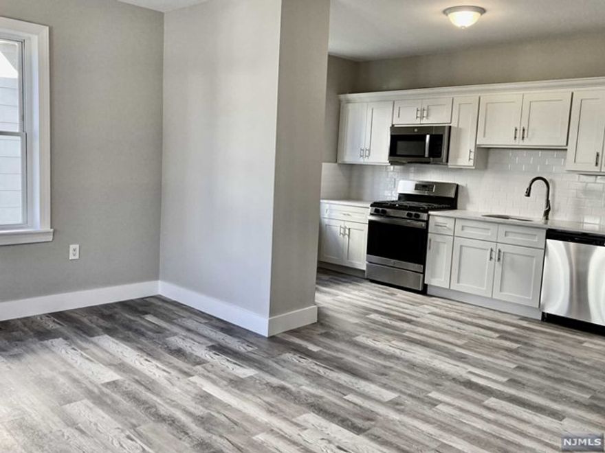 THIS RENOVATED FIRST FLOOR UNIT FEATURES A MODERN OPEN FLOOR PLAN, KITCHEN WITH STAINLESS STEEL APPLIANCES AND QUARTZ COUNTERTOPS OPEN TO DINNING AREA AND LIVING ROOM, TWO BEDROOMS AND ONE BATH. WASHER/DRYER HOOK UPS IN BASEMENT, CENTRAL AIR, SHARED USE OF YARD. WATER INCLUDED, TENANT PAYS ELECTRIC AND GAS. NO SMOKING, NO PETS. WALKING DISTANCE TO N.Y.C. TRANSPORTATION (BUS AND TRAIN). 1 MONTH RENT, 1.5 MONTH SECURITY DEPOSIT AND 1 MONTH FEE DUE AT LEASE SIGNING.