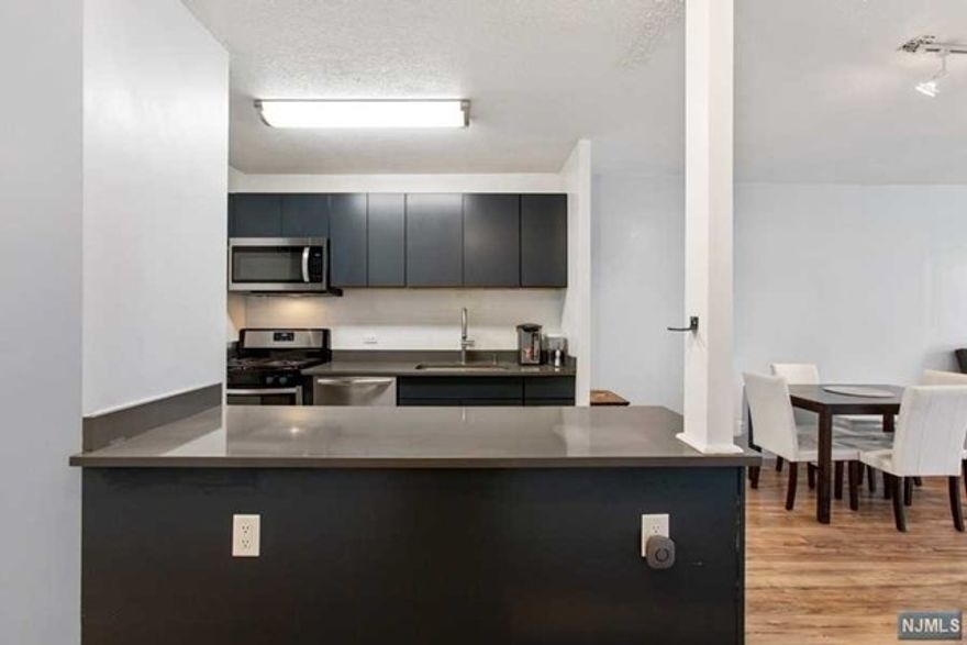 Impeccable Spacious South Facing 1 bedroom apartment with updated modern kitchen in Galaxy Tower! A spacious separate dining room that recently converted into a home office/guest room, with great light all day long. This great apartment features a brand new kitchen with backsplash and quartz countertops, 1.5 bath, the best of all, ALL UTILITIES INCLUDED in its HOA. The Galaxy Towers is a luxury condominium with 24 hour doorman, concierge, Multimillion dollar health club with indoor/outdoor swimming pools, gym, tennis courts, 24/7 transport to NYC at your doorstop. Indoor parking & convenience stores on site.