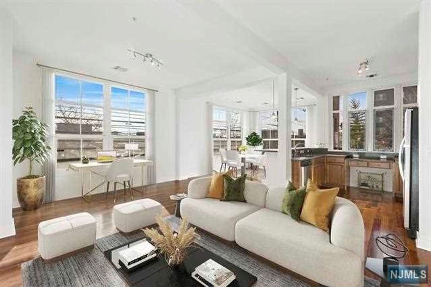 Welcome to The Lofts at Westside Station located in the booming Westside neighborhood of Jersey City! Be amazed as you enter into this bright and airy first floor 2BR/2BA home with private entrance. Stunning loft features include 10 ft ceilings, floor to ceiling windows, hardwood floors throughout, large master bath with soaking tub and stall shower, laundry in unit, great closet space and designated living and dining spaces. This modern kitchen includes breakfast bar, stainless steel appliances, granite countertops and great cabinet storage. Enjoy fresh air from your private terrace! This home has a private entrance and is also an elevator building with keyless secured entry, trash chute on every floor and 1 garage parking space included! The best part? Be in NYC in no time with the Westside Avenue Light Rail station only 1.5 blocks from your front door. Easy access to all major highways as well as restaurants, retail stores, coffee shops, parks and schools.