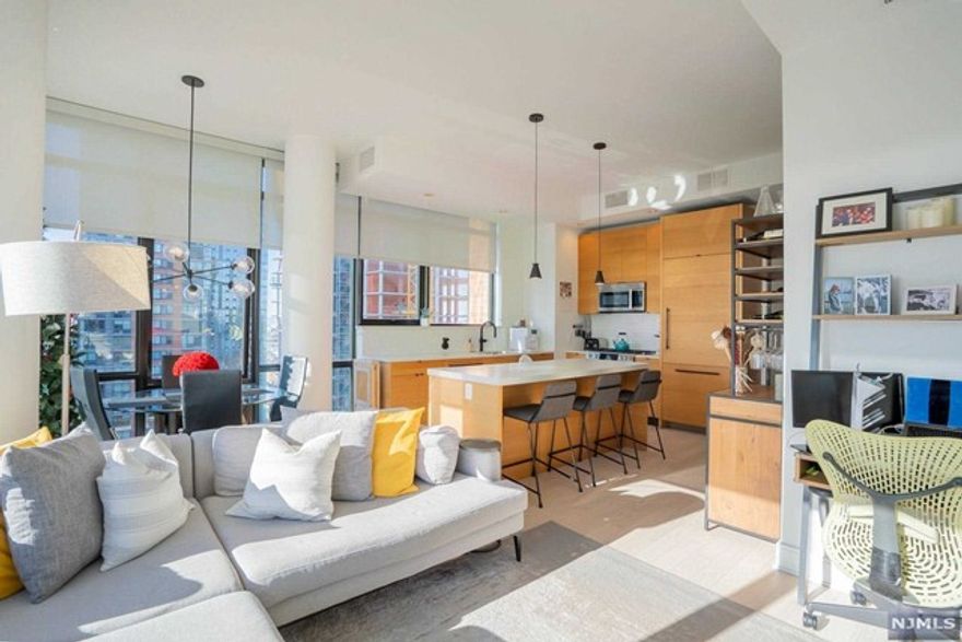 Live in high-end luxury within the most desirable building downtown Jersey City has to offer! Presenting a pristine 2 Bd + 2BA condo with an open layout and luxurious Kitchen with Bosch appliances, Thermador refrigerator, quartz countertops, and a large center island opening to the living and dining areas. The spacious bedrooms include custom cabinets in the closets and the bathrooms include high-end finishes throughout. Floor-to-ceiling windows dressed with custom blinds welcome an abundance of natural light into the home and the view of the Statue of Liberty is simply stunning. This home also comes with in-unit W/D and 1 car garage parking! The building is just two blocks away from the Path station and close to shopping/dining. The building has 27,000 sq ft of amenity space as well! Including a roof deck and sky lounge with beautiful Manhattan views, top-notch gym, pool, kids playroom, party room the list goes on and on!