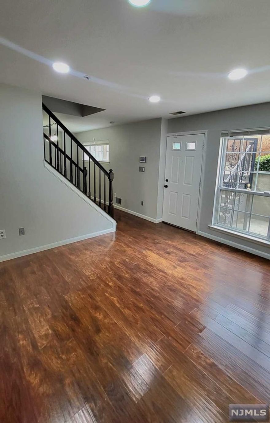 The Society Hill neighborhood is in the University Heights section of Newark. Located in a quiet neighborhood, this spacious two-bedroom, 1.5 bath condo with laundry in the unit, small outdoor area, and storage space features an in-ground swimming pool, tennis courts, a playground, and a clubhouse. One parking space is included and there are visitor spaces nearby and 24-hour security in this quiet community. For an easy commute to NYC, Newark Penn Station and Warren Street Light Rail are just minutes away. Several bus lines can be accessed within walking distance, and Routes 280, 78, and Garden State Parkway are quickly accessible. Everything is close by, including Shoprite, the Essex County Courthouse, Rutgers Medical School and School of Dental Medicine, Rutgers Law School, Saint Vincent Academy, Essex County College, Veterans Memorial Park, University Hospital, and New Jersey Institute of Technology. Check out the virtual tour and floor plans. The Unit is 989 sq. ft.