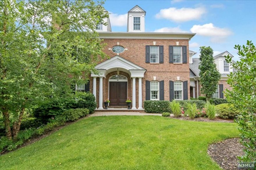 The Saddle River Grand is a premier gated community renowned for its luxurious living standards and prime location in Bergen County. This "Jefferson Model" end unit with approximately 5000 sq.ft. on 3 levels, offers two story foyer with bridal staircases to both upper & lower levels. 2 story Great room with gas FPLC, Custom gourmet kitchen with breakfast room and access to private deck. 1st floor primary suite featuring tray ceiling, 2 walk-in closets, custom bath W/oversized shower stall plus soaking tub. Upper level offers 3 large bedroom/En Suites. Lower-level features family room W/fplc, SGD to private outdoor space, office/playroom, full bath & lots of storage. Elevator to all levels! The Grand offers gated security, club house & OD Pool.