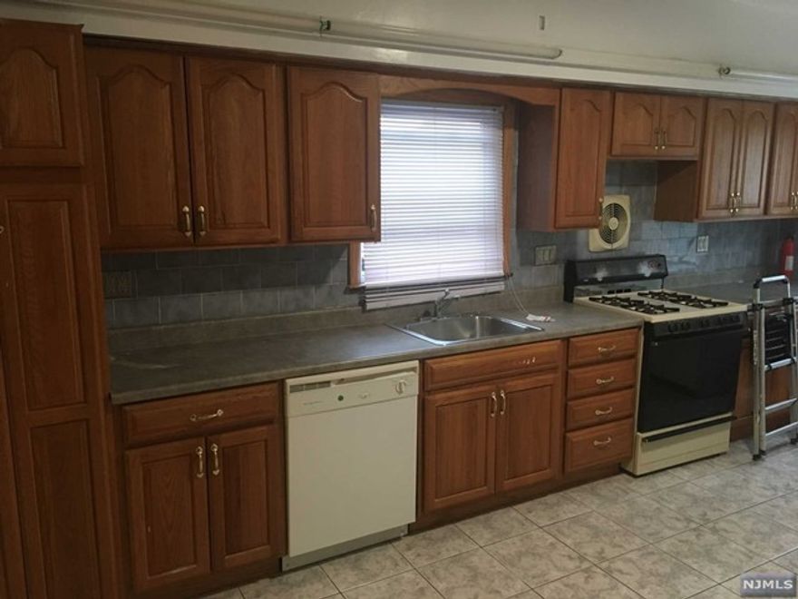 All utilities included. First floor with gleaming hardwood floors. Large rooms. One car parking in rear and laundry in unit. Includes refrigerator and dishwasher. No pets and no smoking in apartment. Front and rear entrances.