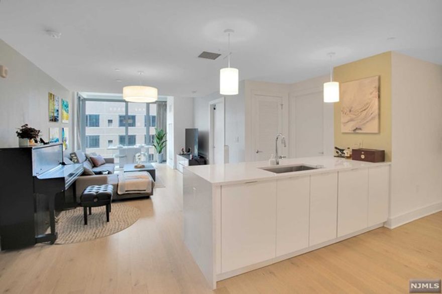 Discover pure modern elegance in the most premier and luxurious new construction building, Nine on The Hudson, located along the desirable NJ Gold Coast waterfront. Enter into this spacious 2 bedroom / 2 Full Bathroom open layout floor plan covering approximately 1,140 sqft with SOUTHERN exposure and partial views of NYC from the balcony. The expansive kitchen includes Aspen quartz countertops, Pedini cabinets, Bosch appliances, and a Thermador refrigerator. Large master suite with a walk-in closet and a customized second bedroom with California Closets, built-in desk, shelving, and Murphy bed. Enjoy wood flooring throughout, in-unit washer/dryer, and oversized windows. This beautifully designed luxury building features breathtaking views of NYC with 40,000 sqft of resort-style amenities: 24-hour doorman, state-of-the-art fitness center, amenity deck with infinity swimming pool and BBQ area, rooftop deck with cabanas, shuttle to/from Ferry. Welcome home to Nine on the Hudson!