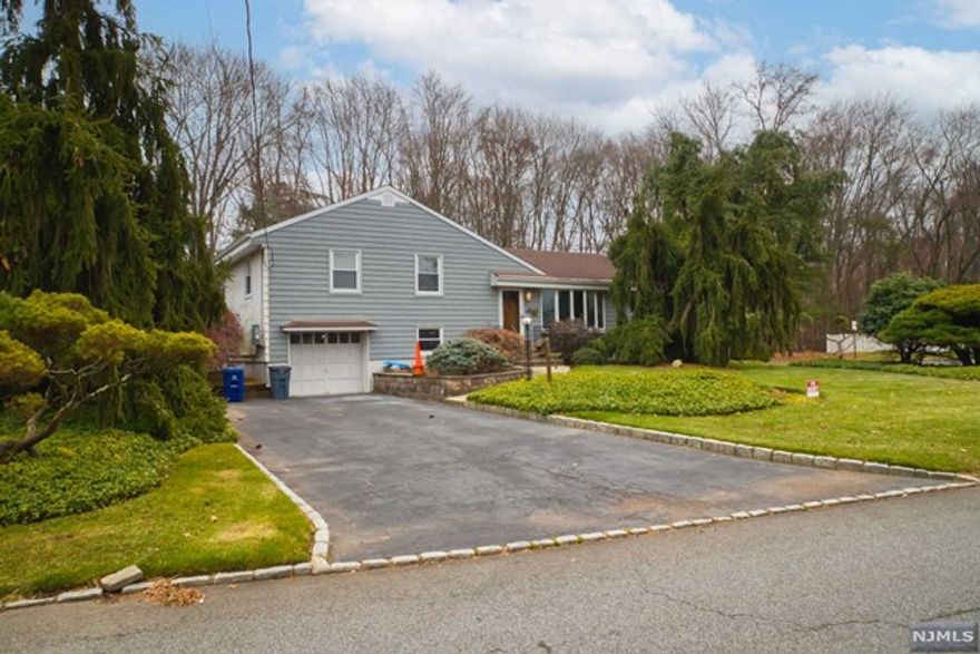 Welcome home to this lovely split level home featuring 3 bedrooms and 2 full bathrooms located on a quiet street on large private yard. Backing up to Highland Field, with fields and walking path. The bright living room features hardwood flooring and a cozy fireplace. Entertain in the large formal dining room with access to a 3 season screened porch and eat in kitchen. On the second level, you will find a large Primary suite complete with modern full bath. 2 additional bedrooms and full bathroom complete the second floor. The walk out lower level includes a home office/recreation room laundry, utilities and attached 1 car garage. Harrington Park features top schools, beautiful reservoir, parks, swim club, open spaces and access to Manhattan.