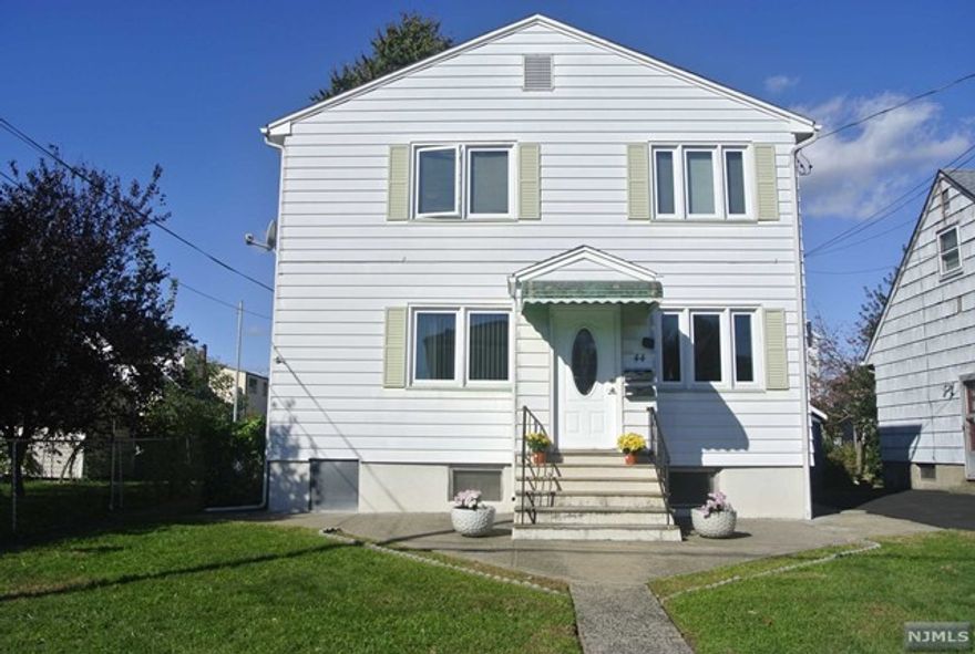 Beautiful, updated 1st floor unit, freshly painted, with 5 rooms. Bright living room with hardwood floor, kitchen with island open to dining area with sliding door to a nice and private deck, 2 bedrooms with hardwood floor, organized closets, full bathroom. separate entrance. Laundry in the basement with washer and dryer, storage space. Conveniently located, close to NYC transportation and local shops and restaurants.