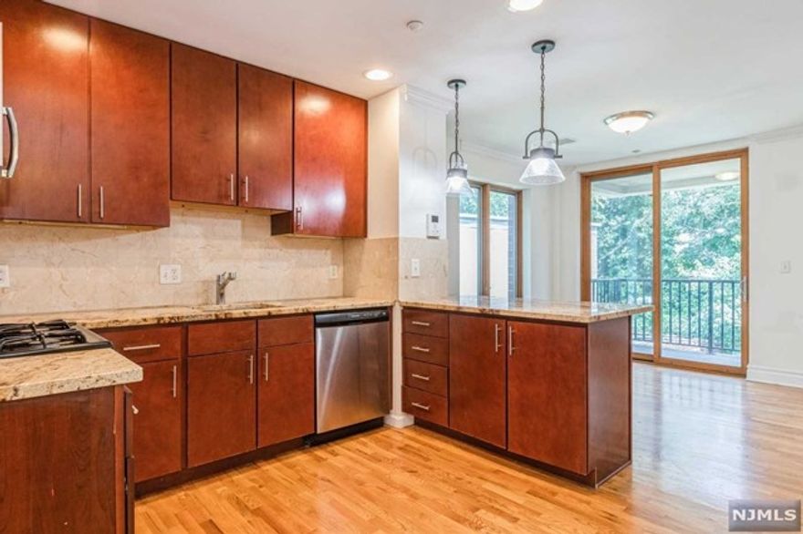 Welcome to The Gate! This is a 1069 sft 2 bed/1 bath. The unit is north, east and west-facing in a modern, 5 story, brick, elevator building just 2 blocks from the Rutherford train station and close to buses. Each unit offers hardwood floors, crown and base moldings, granite countertops, stainless steel appliances, washer/dryer in unit, keyless, entry, private balcony, central A/C and video intercom. Pet frienldy up to 40lbs with a one-time, non-refundable $350 pet fee. Gated parking available - $100/month for an uncovered spot, $150/month for covered, non-garage parking. BROKER FEE PAID BY LANDLORD.